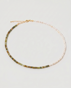 multi gemstone and pearl beaded necklace in gold, with one half strung with imitation pearl rice beads and the other half with faceted mixed quartz beads in green, sage, olive and warm brown tones, joined by a gold accent bead.