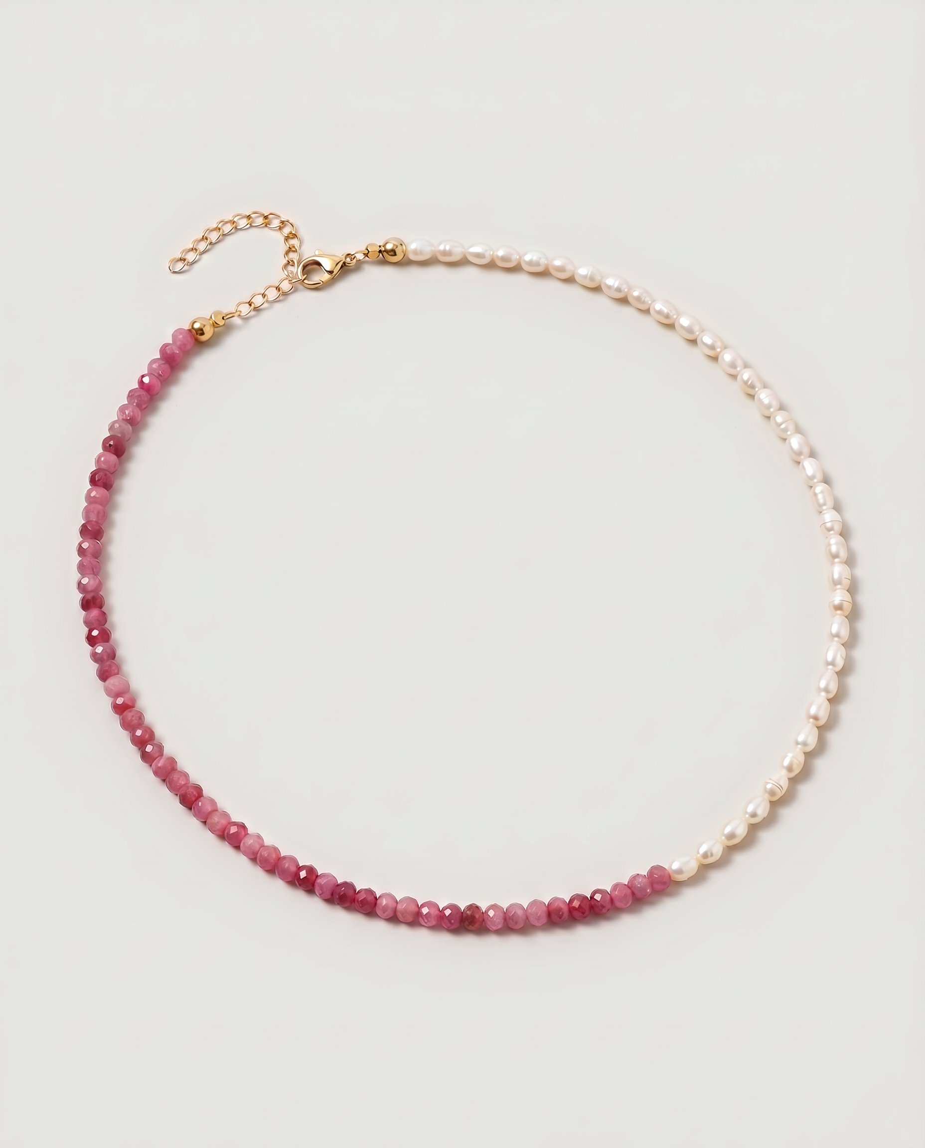  Rose quartz and pearl beaded necklace in gold, with one half strung with imitation pearl rice beads and the other half with faceted rose quartz beads graduating from soft blush to deep pink.