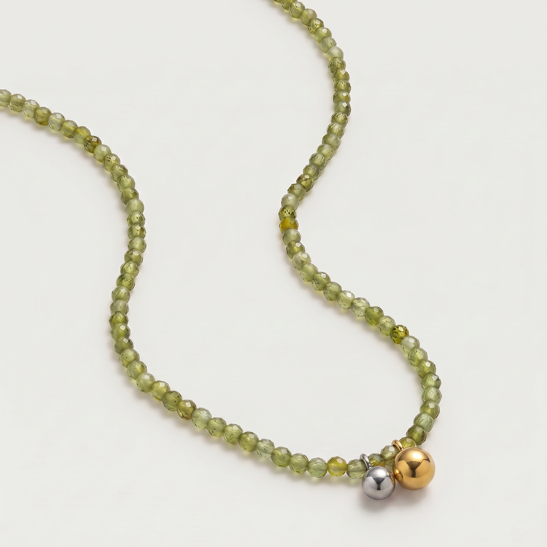 Olive green beaded necklace in gold, with green cubic zirconia beads and a two-tone pendant 