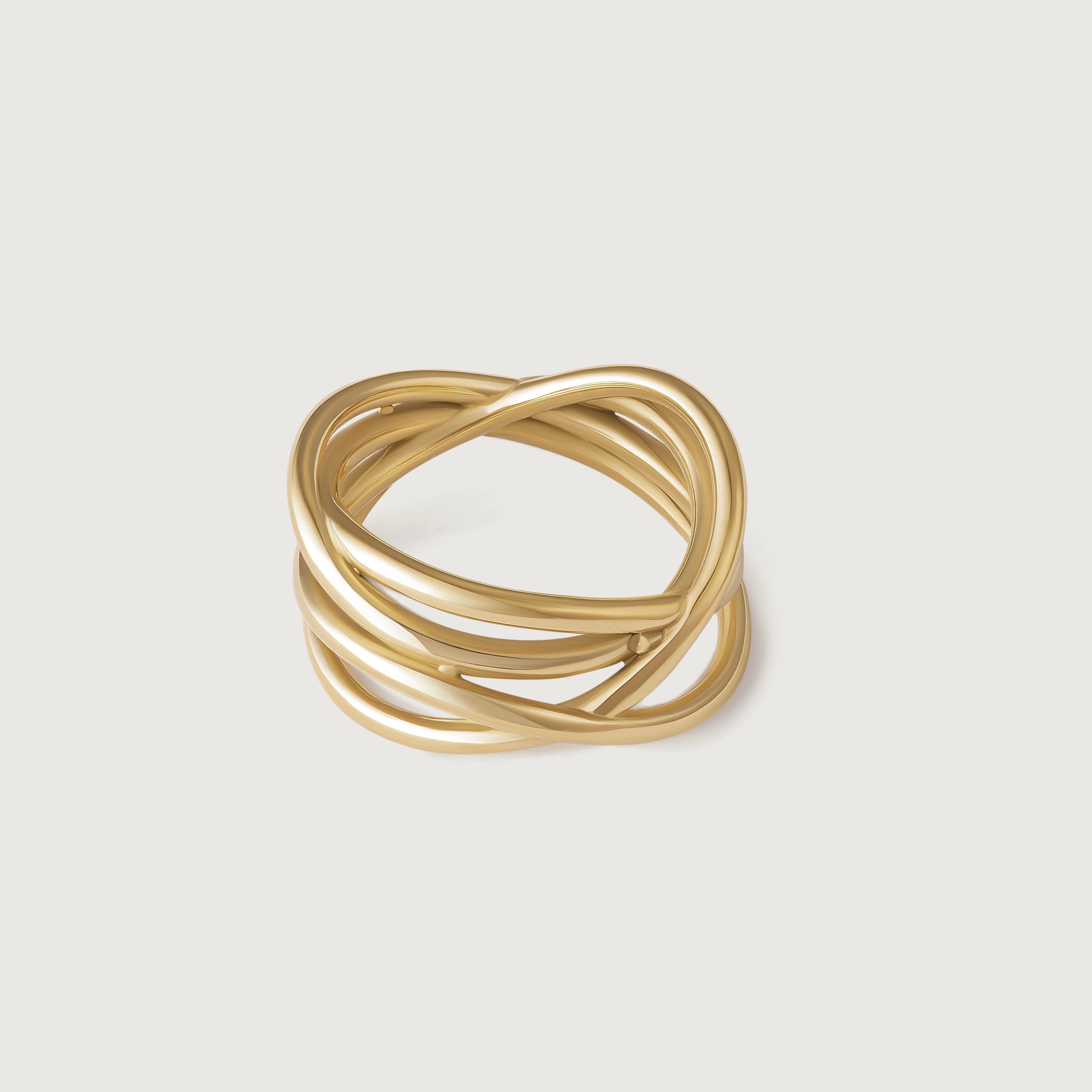 A gold-plated ring with multiple intertwined bands, displayed against a white background.