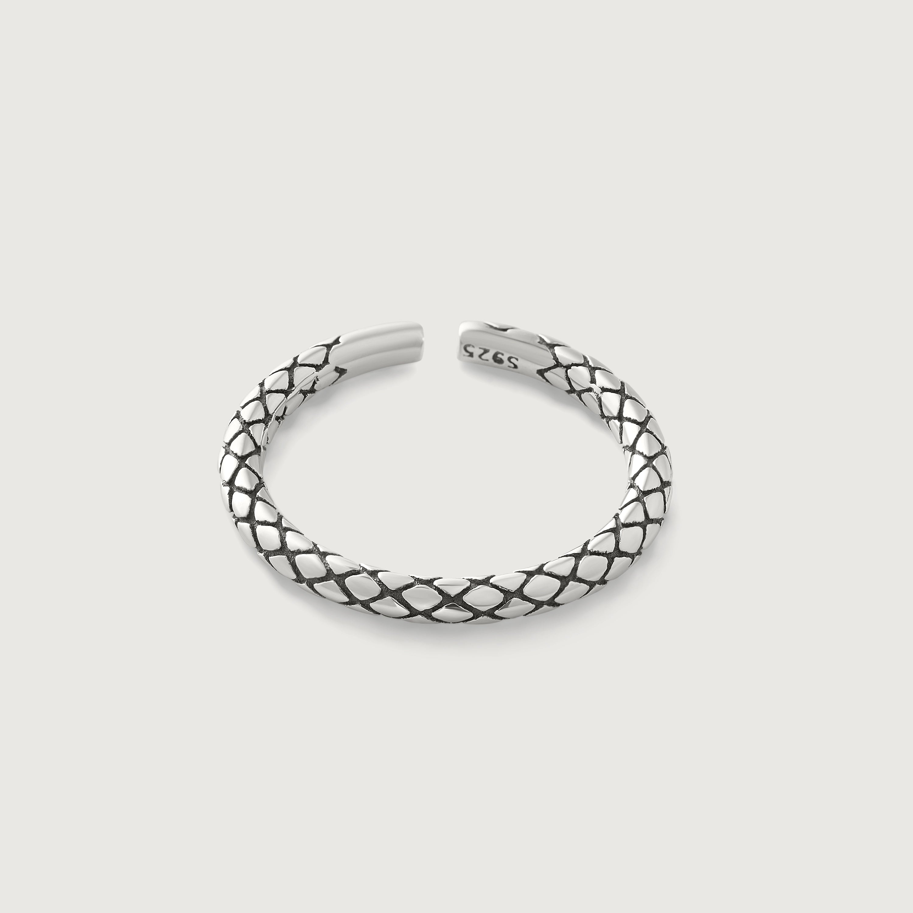 A sterling silver ring with an intricate scale-like pattern, featuring an open-ended design for adjustable sizing.