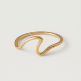 A gold-plated open wave ring on a white background.