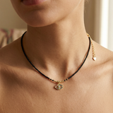 close up of a female wearing a devil eye pendant necklace