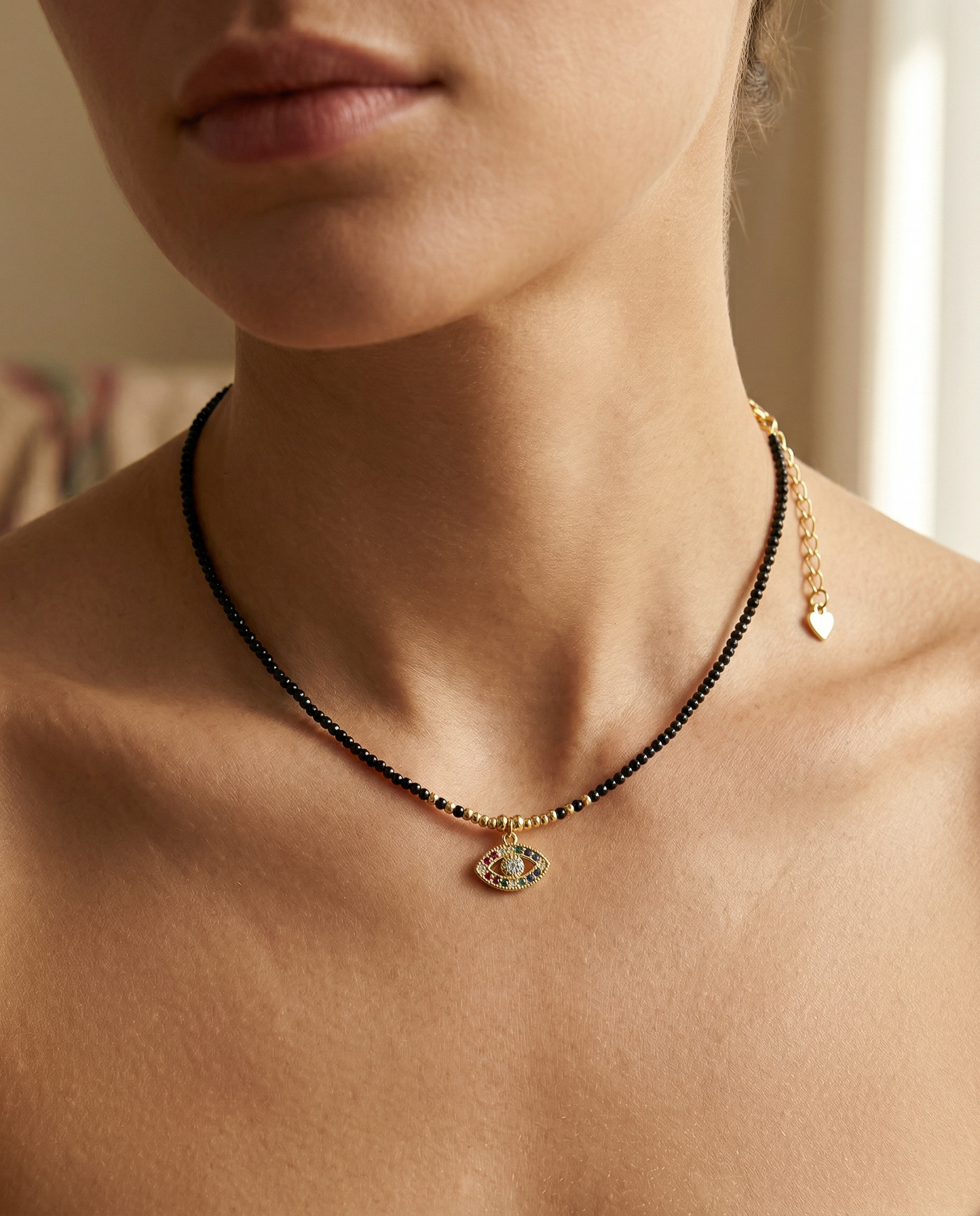 close up of a female wearing a devil eye pendant necklace