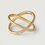 A gold ring with two intersecting bands and small stones set along one band.