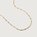 A gold-plated necklace with multicolored beads in red, pink, blue, and green, arranged in a alternating pattern between golden bars.