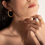 model wearing gold plated rings and necklace