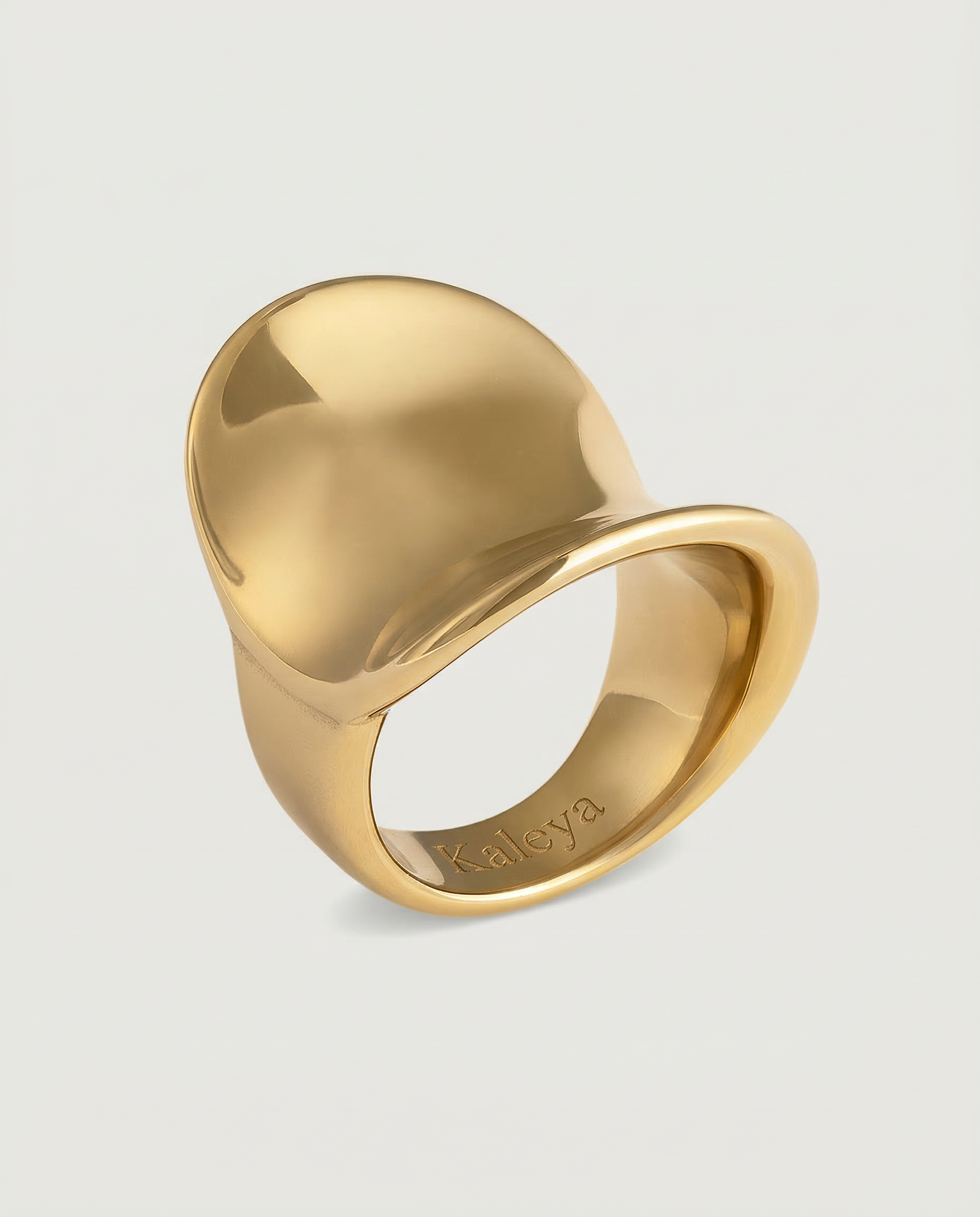A gold-plated stainless steel ring with a smooth, shiny finish and a substantial silhouette.