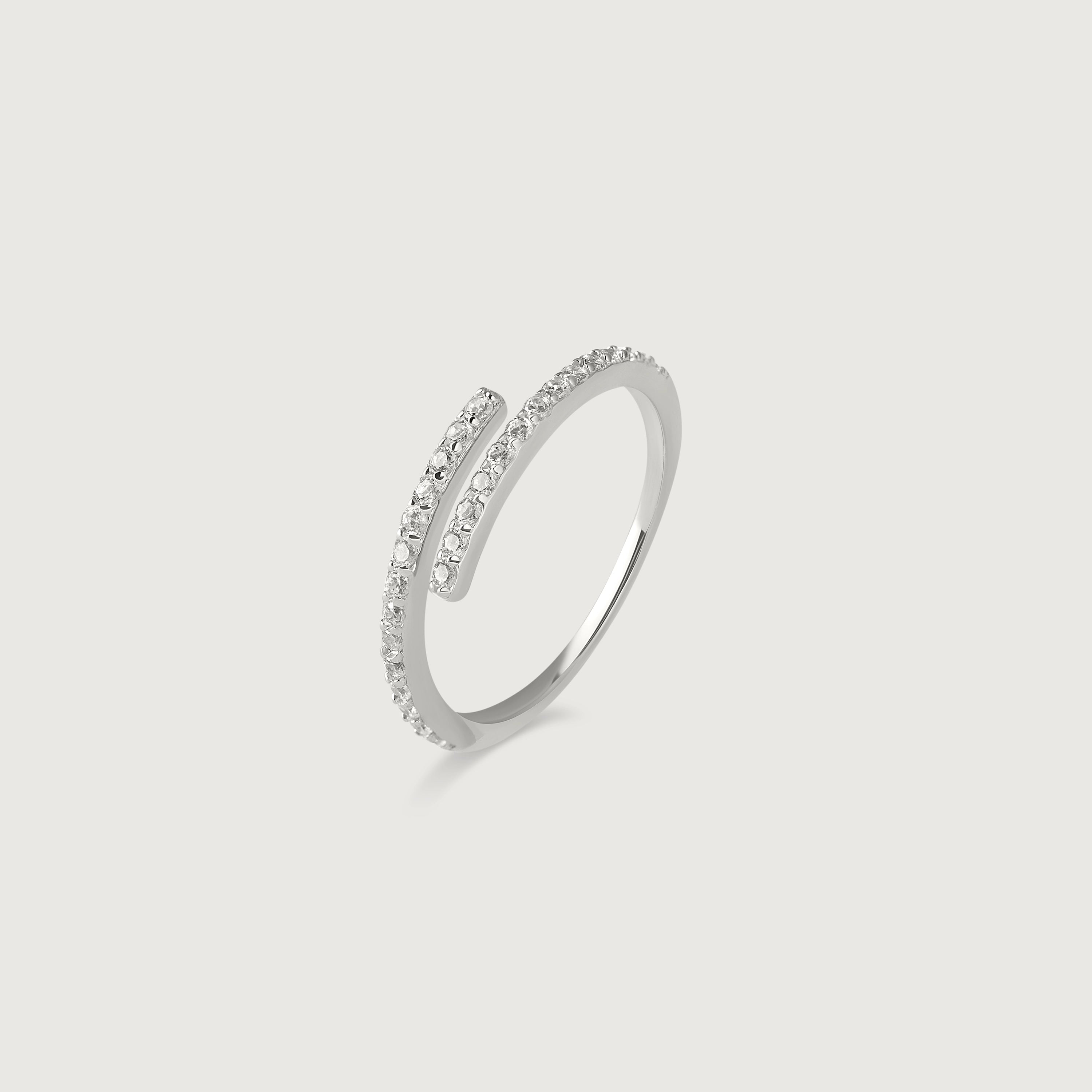 A silver ring with an open spiral design adorned with sparkling cubic zirconia stones, displayed against a white background.