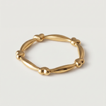 A gold-plated ring with heart-shaped links and elongated bars creating a chain-like design.