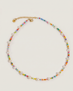 Necklace with multicolored beads and pearl-like elements on a light gray background