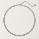 A  sterling silver snake chain necklace with an adjustable length and a heart charm