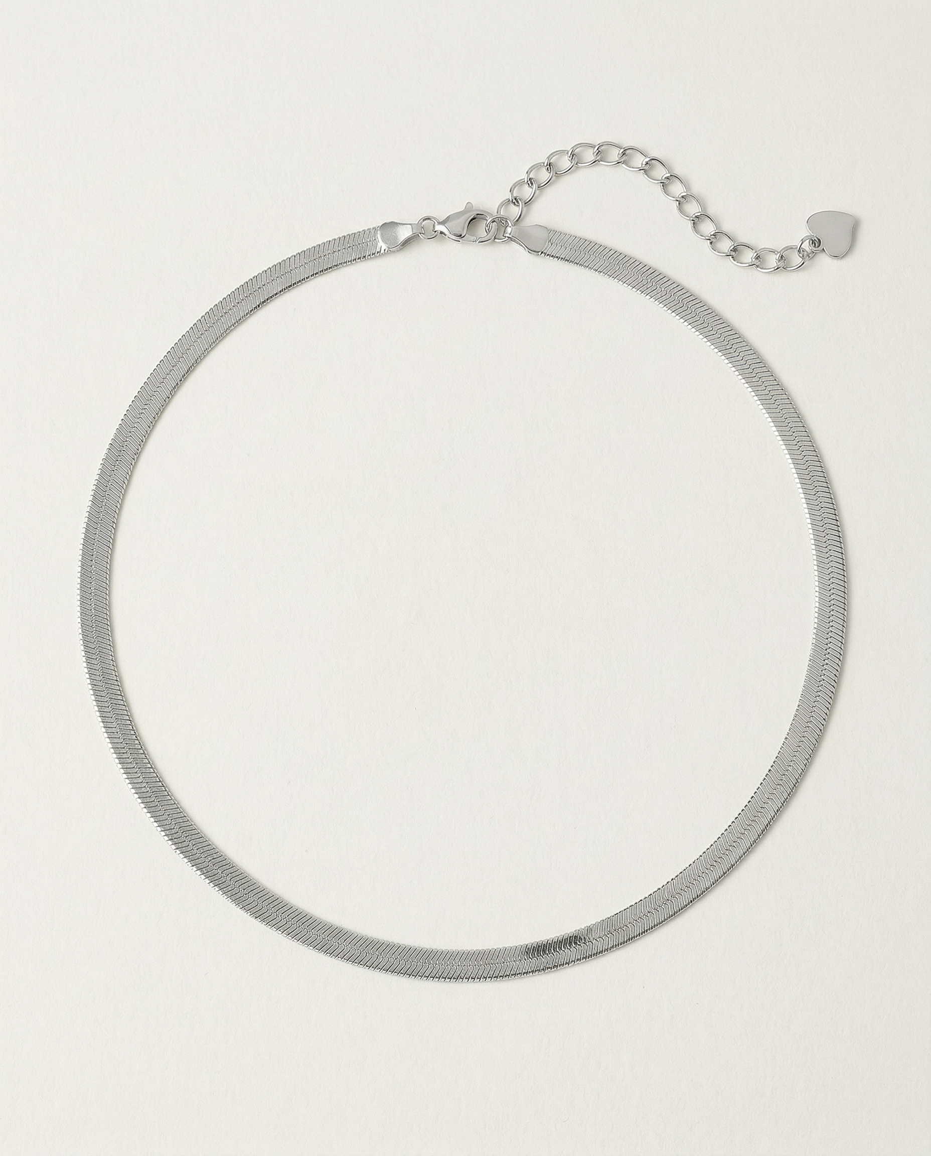 A  sterling silver snake chain necklace with an adjustable length and a heart charm