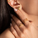 close up of a model wearing delicate gold plated rings