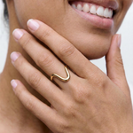 close up of a female model wearing a statement 18k gold plated ring
