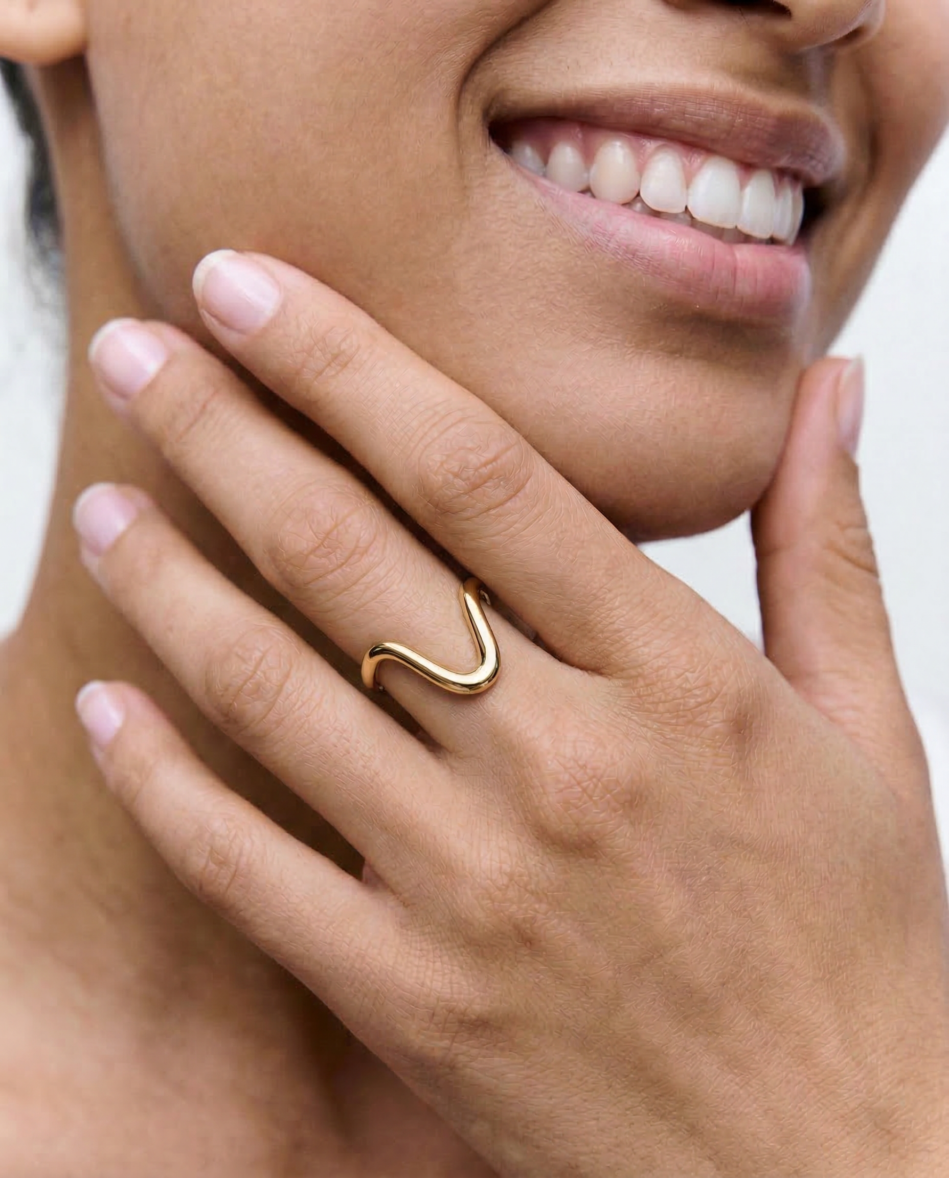 close up of a female model wearing a statement 18k gold plated ring