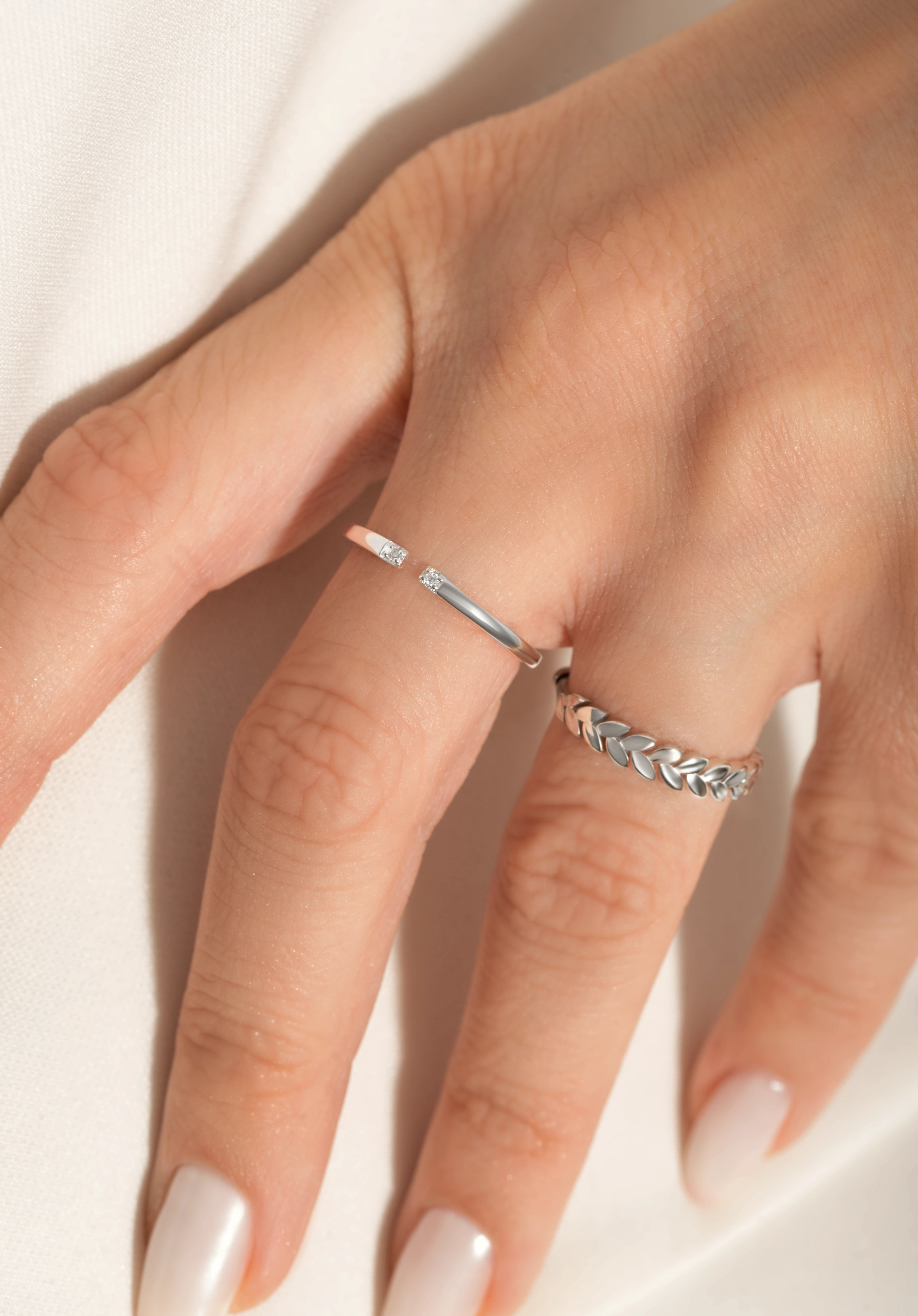 close shot of a model wearing 2 sleek sterling silver rings from Kaleya Studio