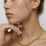 model wearing  a gold-plated mesh necklace 