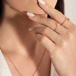 young female model wearing gold plated ring with a natural freshwater pearl