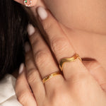 close shot of a model wearing 2 delicate gold rings