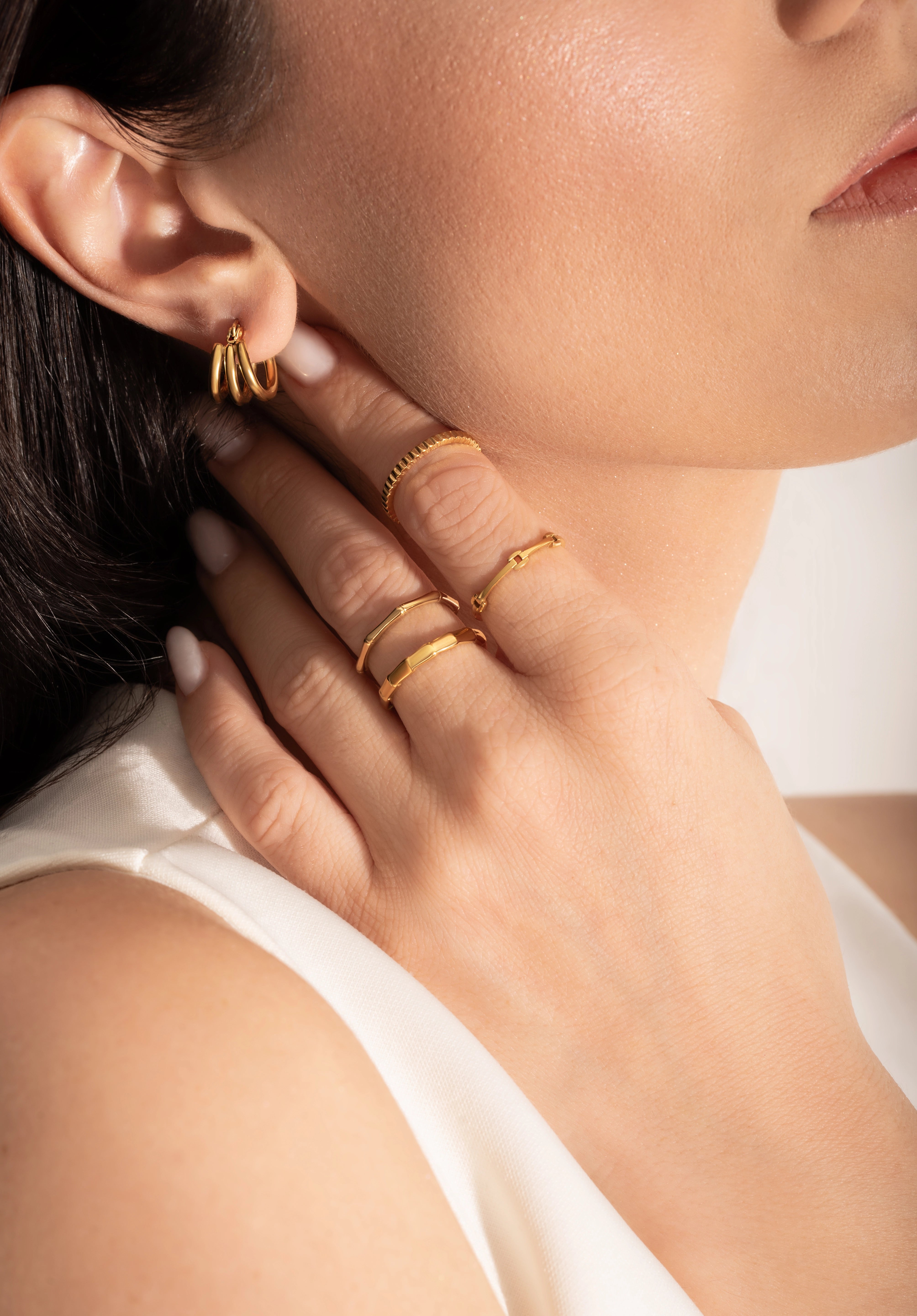 close up of a model wearing multiple 2mm gold plated rings