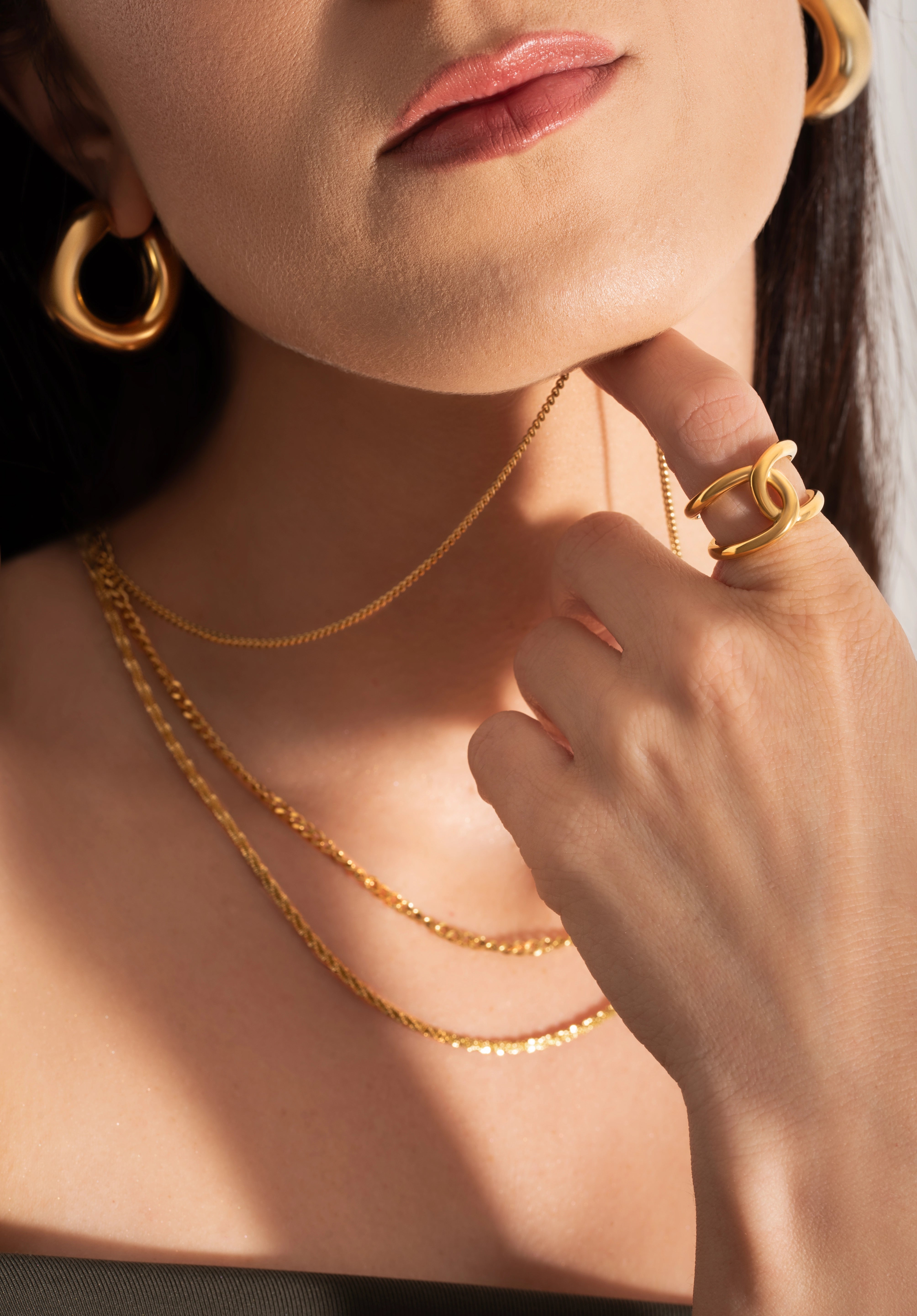 model wearing bold and statement gold plated jewellery