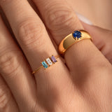 close up of a model hand wearing a delicate cocktail and a statement ring
