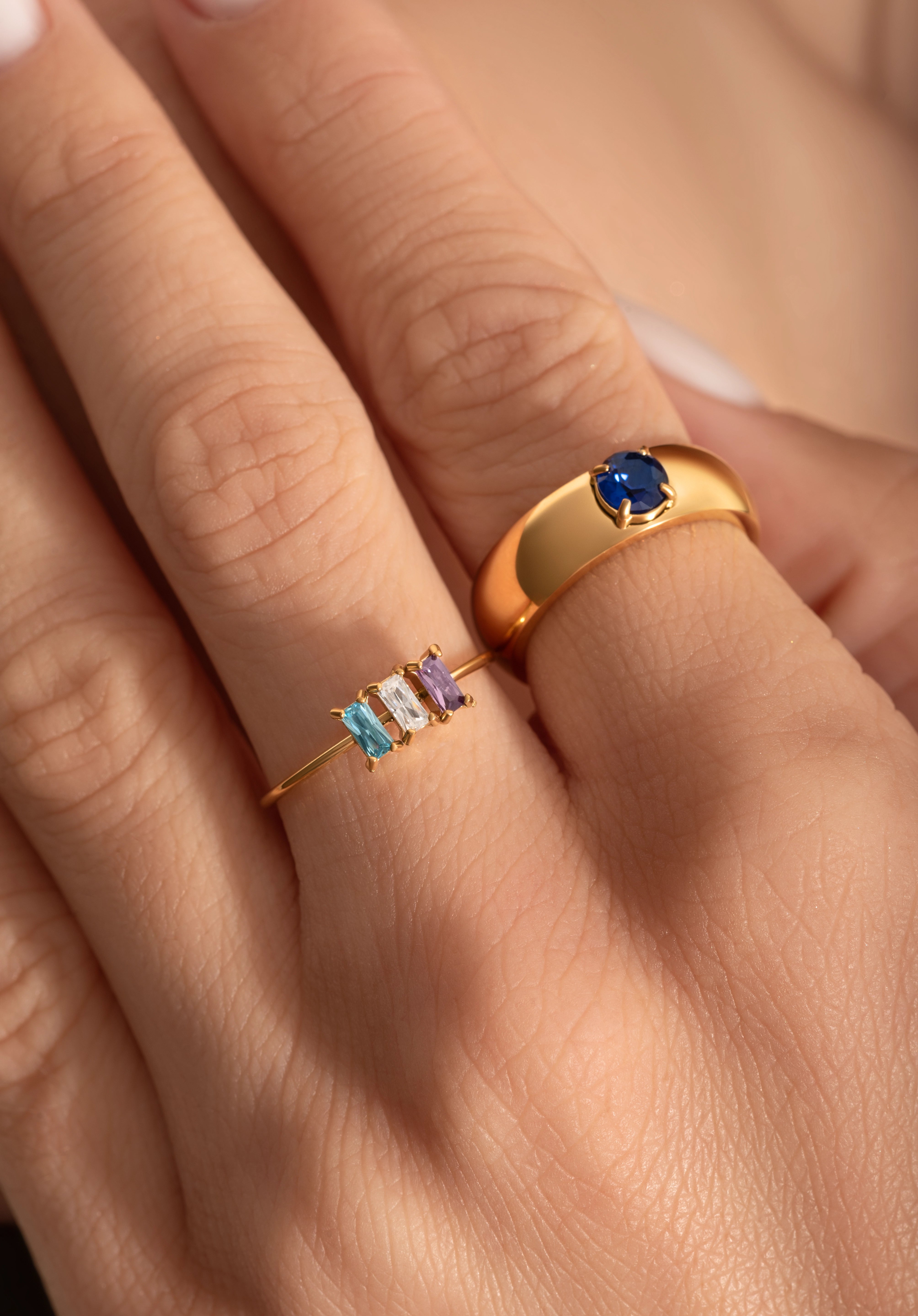 close up of a model hand wearing a delicate cocktail and a statement ring