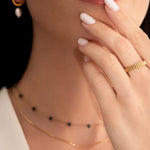 model wearing a gold-plated band ring with fluted edges