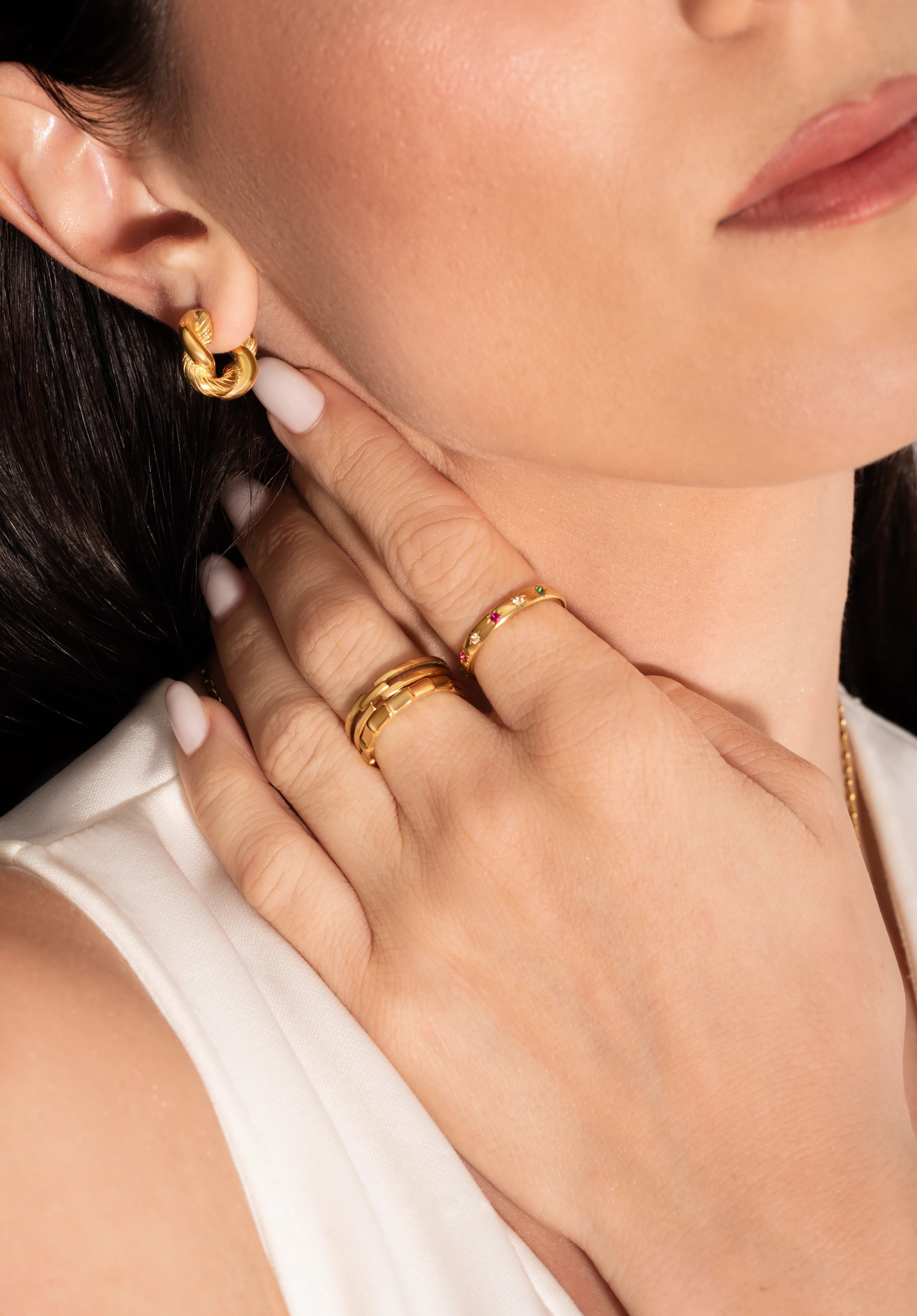 close up of a model wearing 18k gold plated jewellery