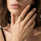 close up of a model wearing v shape gold plated ring