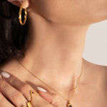 close photo of model wearing statement and delicate gold plating rings