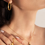 close photo of model wearing statement and delicate gold plating rings