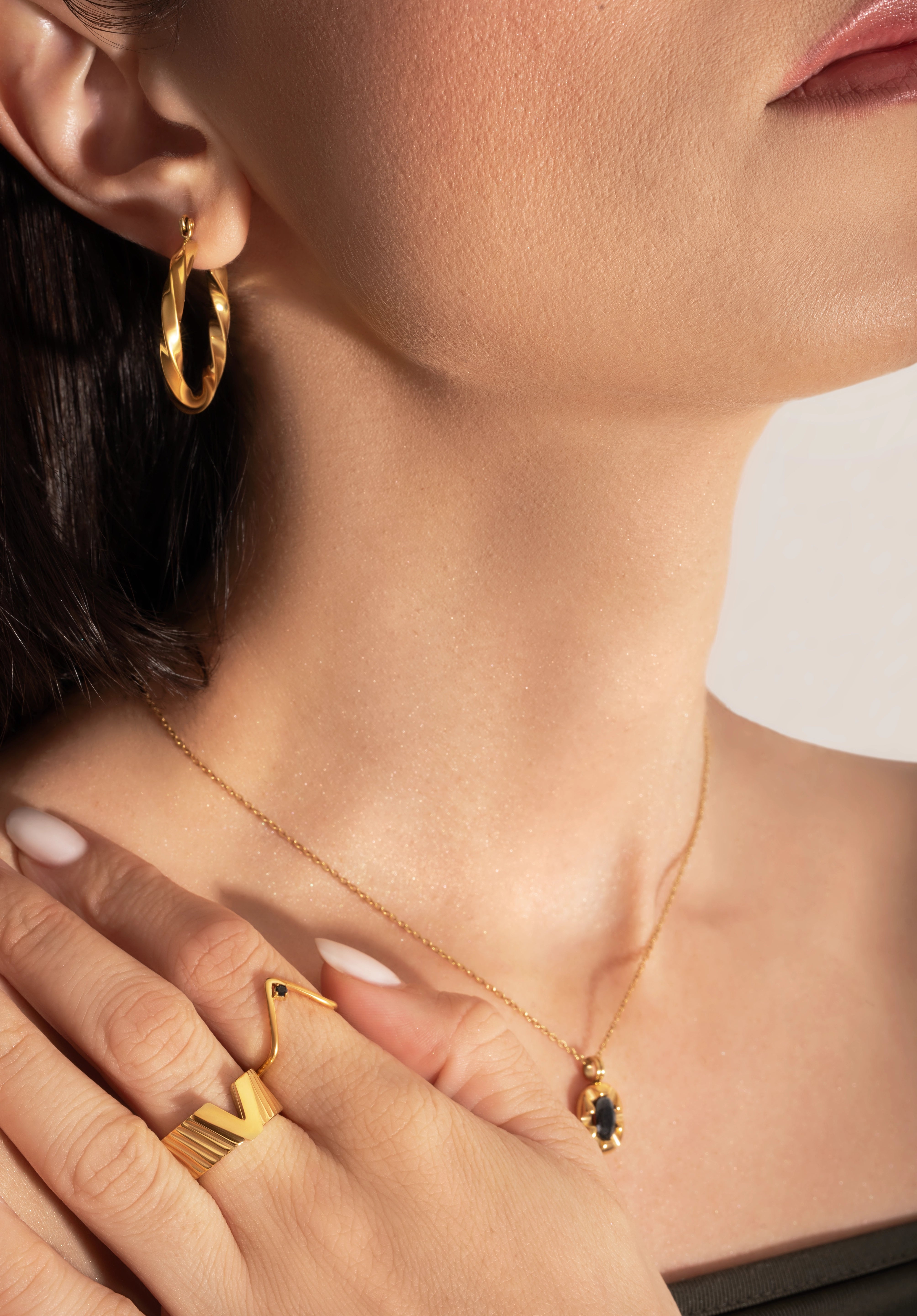 close photo of model wearing statement and delicate gold plating rings