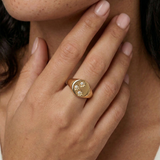 model wearing a signet ring with 3 crystals