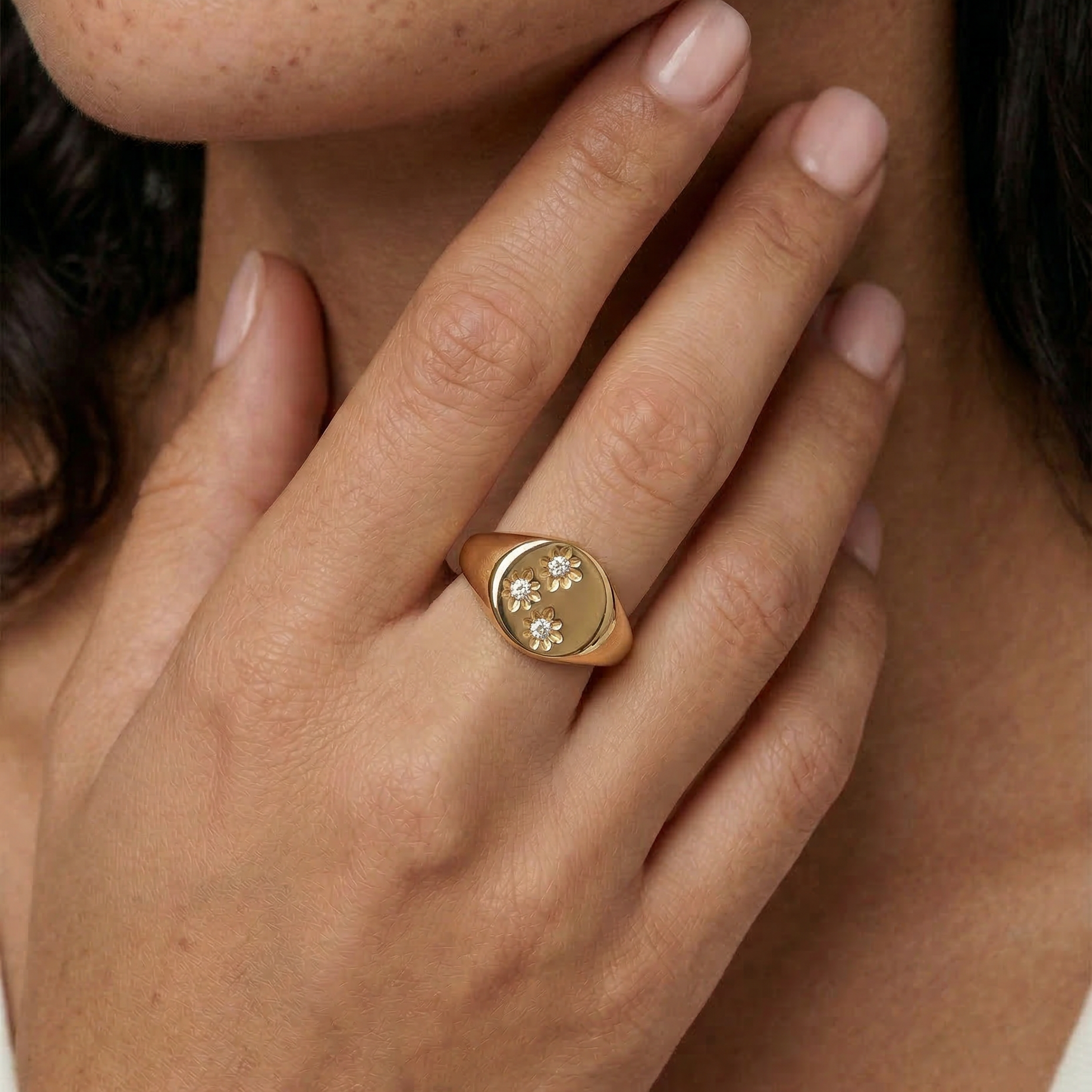 model wearing a signet ring with 3 crystals