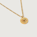 A gold-plated curb chain necklace with a round zodiac wheel pendant featuring multicolored sparkling crystals and a central moonstone.