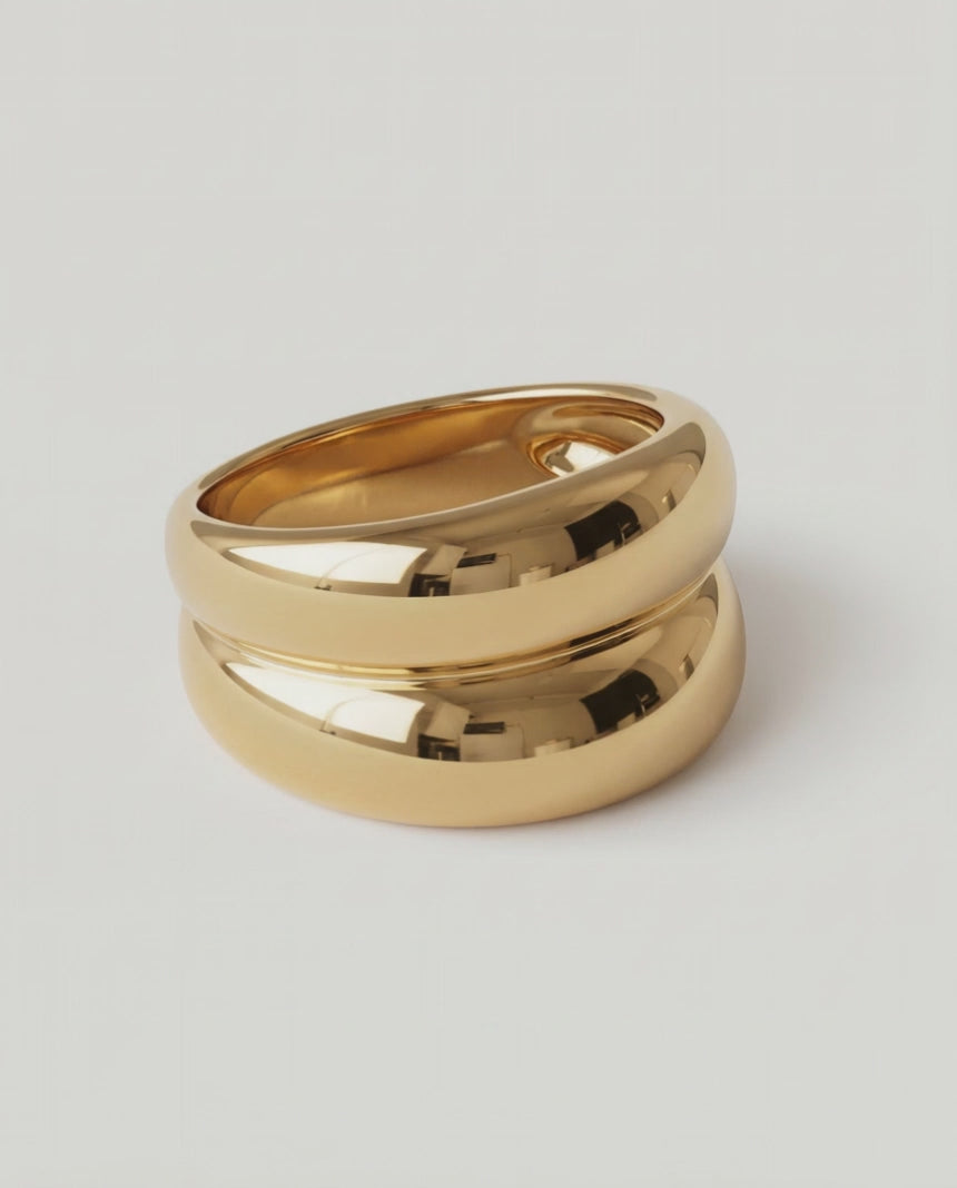 rotating video of a gold-plated ring with a smooth, curved design 