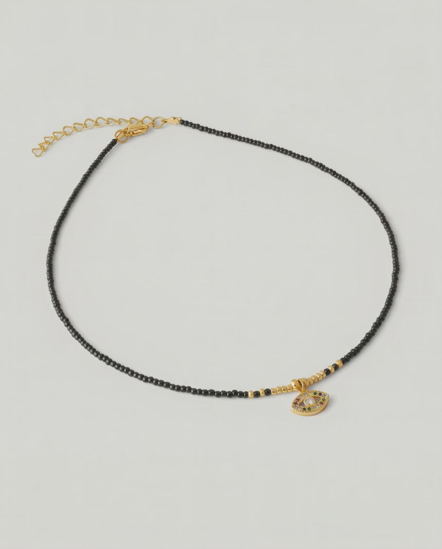 video of A gold-plated choker necklace with black beads and a crystal-embellished evil eye pendant