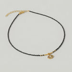 video of A gold-plated choker necklace with black beads and a crystal-embellished evil eye pendant
