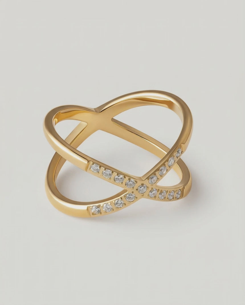 rotating video of a gold ring with two intersecting bands and small stones set along one band
