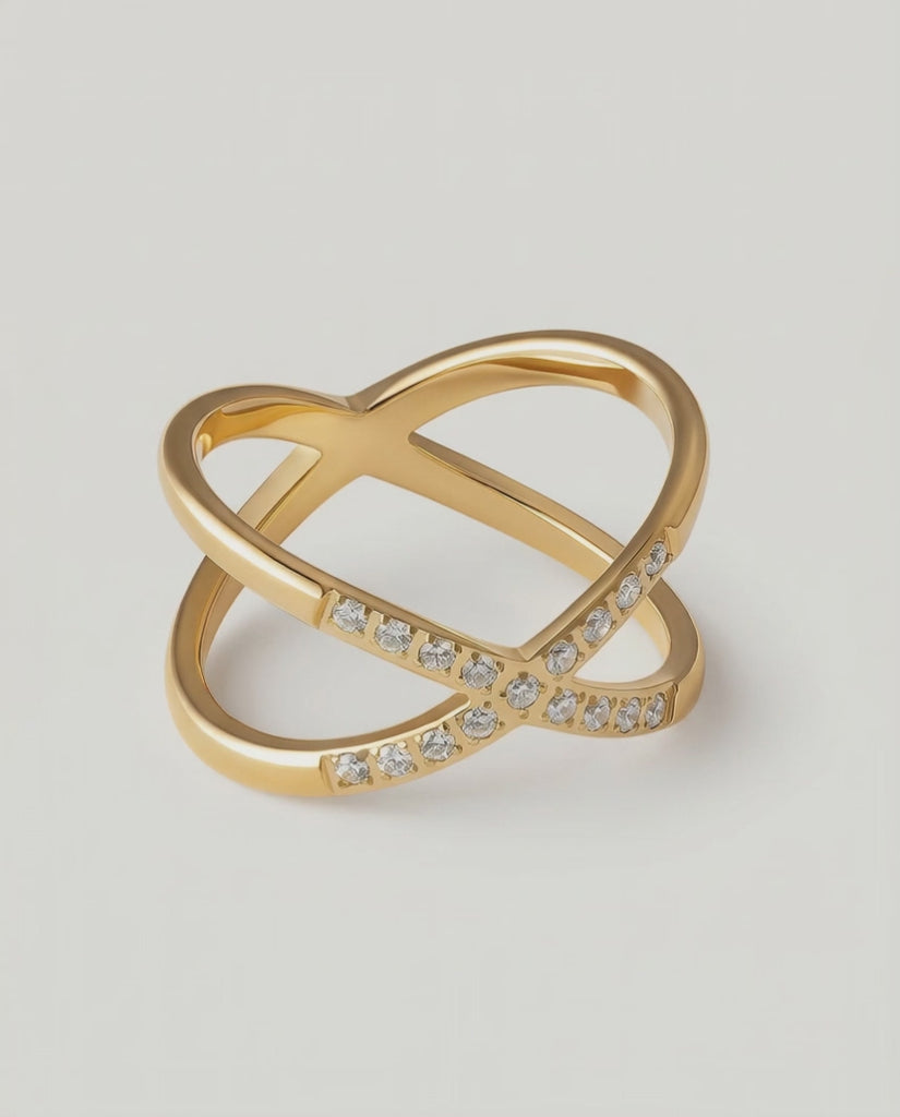 rotating video of a gold ring with two intersecting bands and small stones set along one band