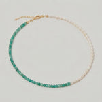 video of a green aventurine and pearl beaded necklace in gold, with one half strung with pearls and the other half with faceted green aventurine beads in fresh green tones.