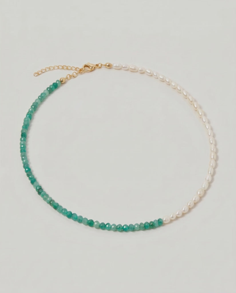 video of a green aventurine and pearl beaded necklace in gold, with one half strung with pearls and the other half with faceted green aventurine beads in fresh green tones.