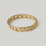 360 rotating video of a gold-plated ring with a chain-inspired design, displaying a sleek, polished surface.