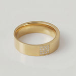 rotating video of a gold-plated stainless steel ring with a polished finish and a section of the band adorned with pavé-set stones.