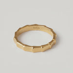 360 rotating video of a gold-plated ring with a textured surface designed to mimic bamboo segments