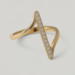360 rotating video of a contemporary gold-plated ring with an asymmetric design featuring a sleek bar adorned with a line of sparkling stones