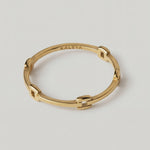 rotating video of a gold-colored ring with geometric cutouts, crafted from gold-plated metal, displayed against a white background.
