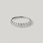 video showing a sterling silver laurel leaf band ring with a polished finish, featuring a series of leaves encircling the finger.